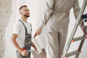 Family repairs. Couple at home. Woman in a overalls